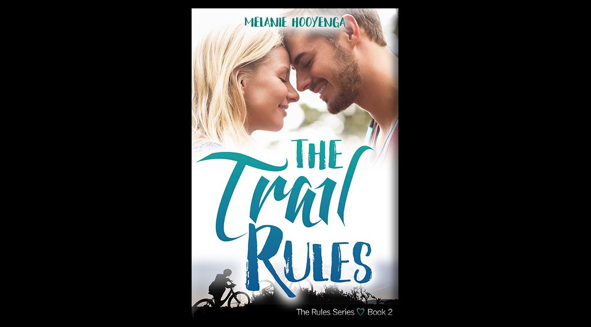 This is the cover of The Trail Rules, by Melanie Hooyenga. The cover features a woman with blond hair and a guy with short dark hair, leaning their foreheads against each other.